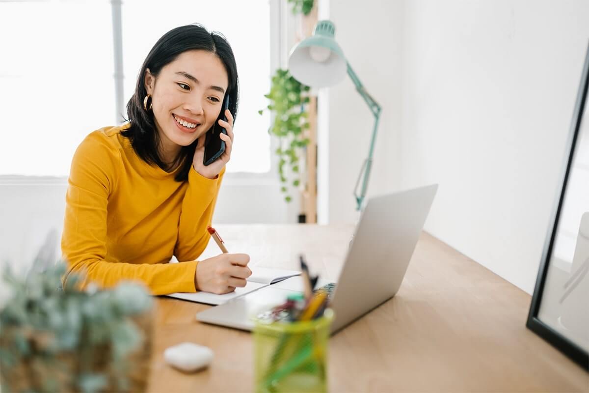 a young women who is a virtual executive assistant from Rocket Station, making a phone call to a potential client.