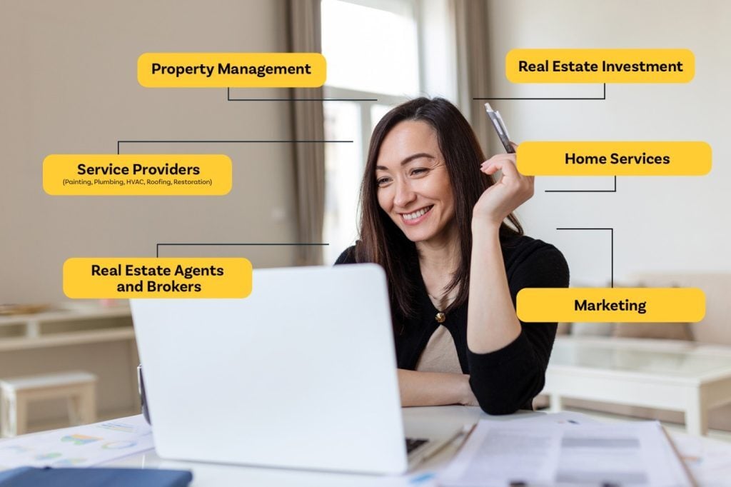 smiling woman holding a pen and viewing her laptop, working as a virtual assistant
